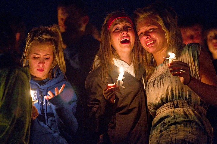 &lt;p&gt;Alyssa Yarbrough, right, and Lizzie Armon comfort each other during the candlelight vigil while standing alongside Nikki Kraft.&lt;/p&gt;