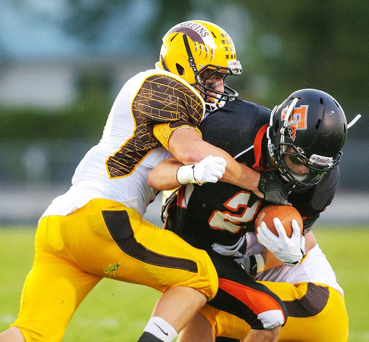 &lt;p&gt;Flathead wide receiver Alex Croymans is taken down by two Helena Capital defenders in the first half of Friday night&#146;s Class AA football game at Legends Stadium.&lt;/p&gt;