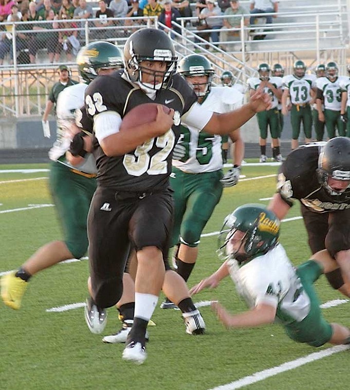 Damien Delarosa, 32, of Royal High School, breaks through the left side of the Quincy defensive line en route to a 100-yard rushing night.