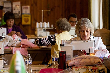 &lt;p&gt;Linda Cathey, of Hauser, a member of the North Idaho Quilters, sews a pillow Monday during a sew day with the Bags and Boob Babes Too group at the Mica Flats Grange Hall south of Coeur d&#146;Alene.&lt;/p&gt;