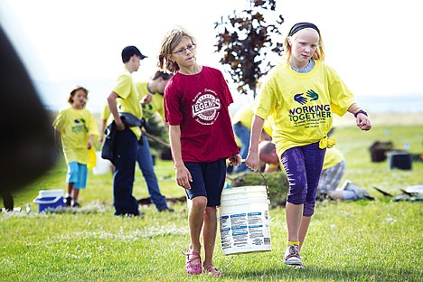 &lt;p&gt;During a day of service hosted by the church of Jesus Christ of Latter Day Saints, Ellie Tenbrink, 10, left, and Brooke Bentley, 10, carry a bucket of water to a group of tree planters Satruday at Majestic Park in Rathdrum.&lt;/p&gt;