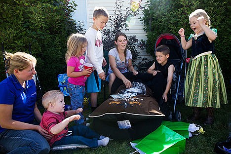&lt;p&gt;Luke&#146;s mom, Debra Ackerman, center, surrounded by friends and family opens a new dog bed for Silas at the welcome party for Silas on Saturday afternoon. Make-A-Wish provided all the supplies needed for a new dog plus one year of veterinary care.&lt;/p&gt;