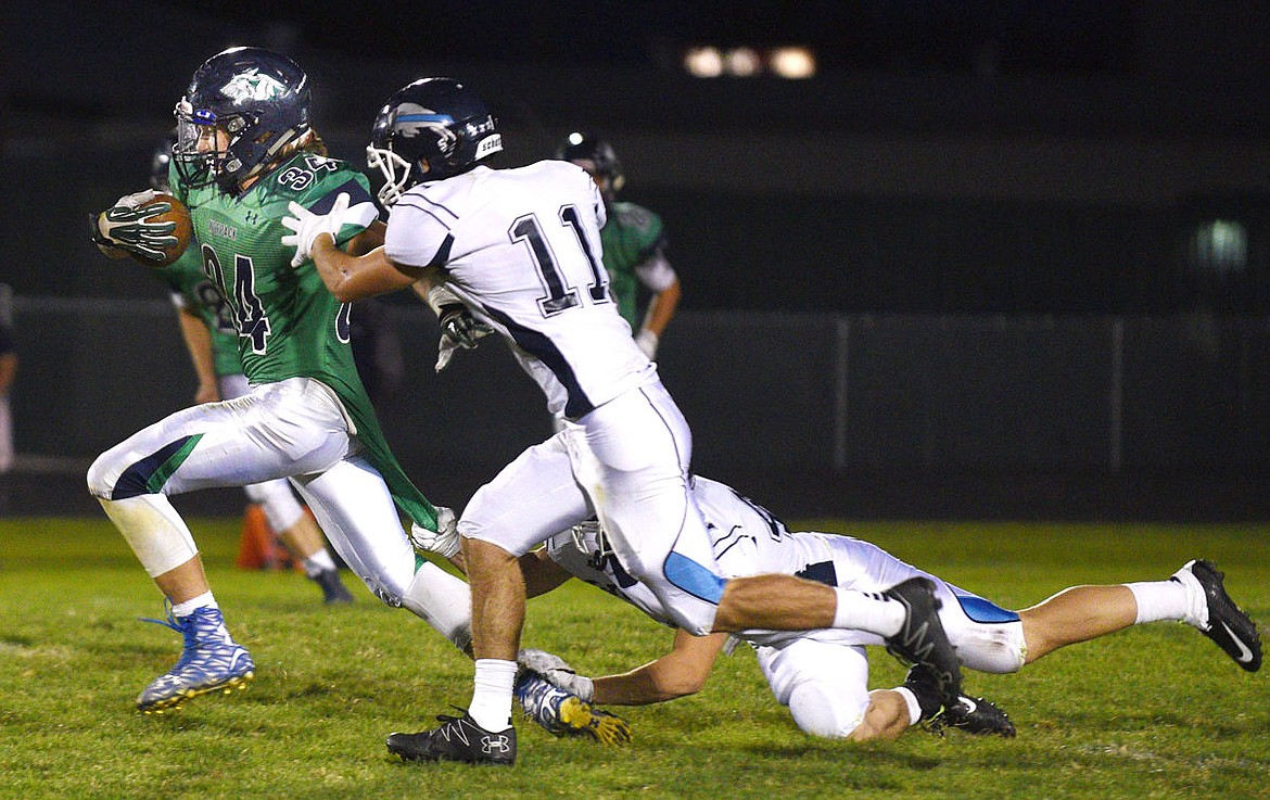 &lt;p&gt;Glacier running back Cole Crosby drags a Bison defender as he goes for a long run to start the third quarter. (Aaric Bryan/Daily Inter Lake)&lt;/p&gt;