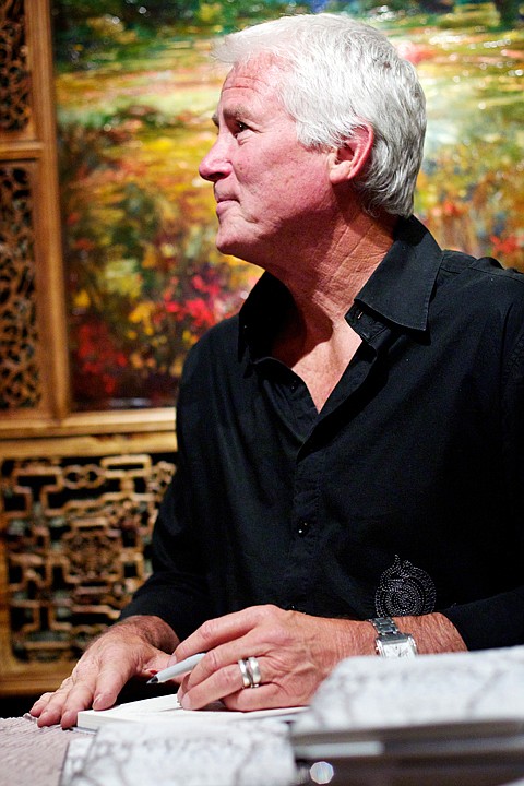 <p>JEROME A. POLLOS/Press Stephen Shortridge signs copies of his book "Deepest Thanks, Deeper Apologies" during an event Friday at his art gallery in downtown Coeur d'Alene.</p>