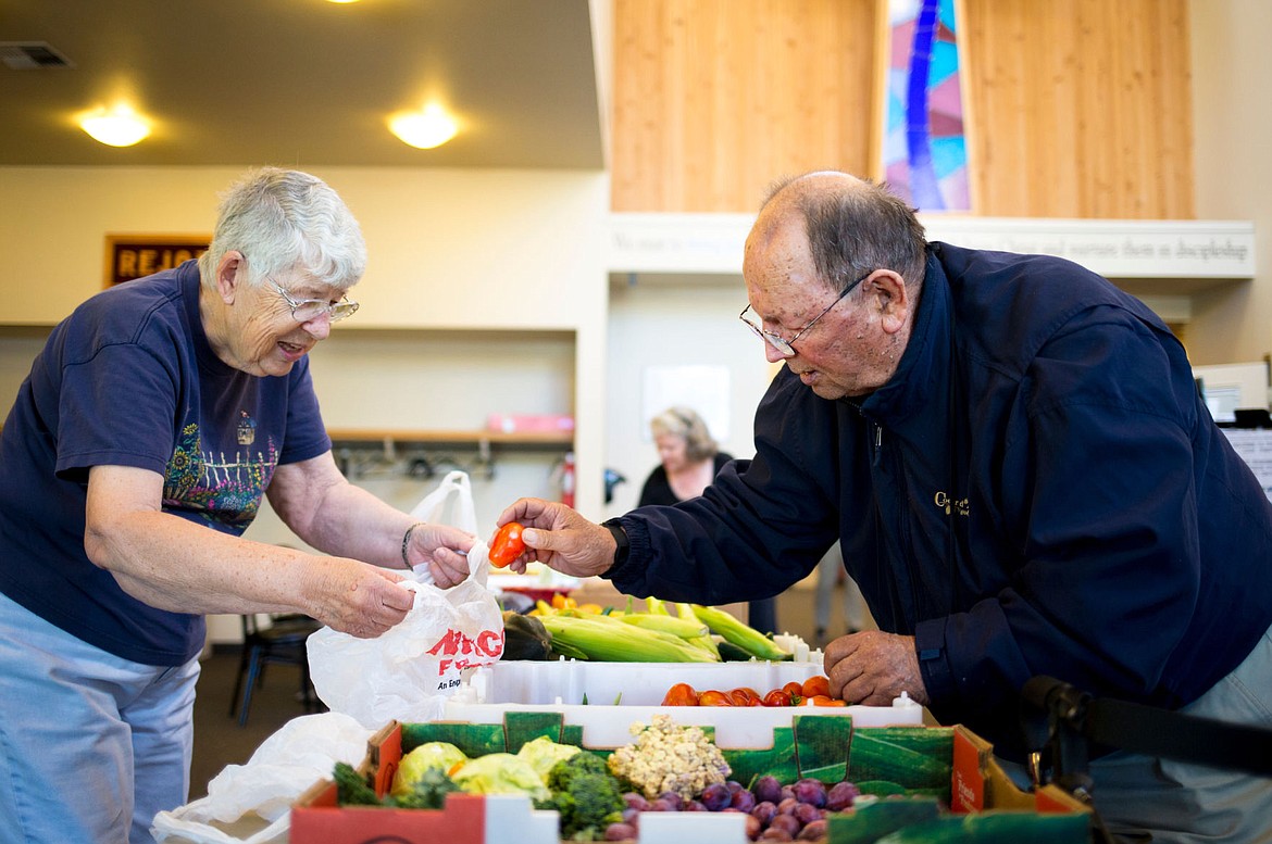 &lt;p&gt;Love Pantry volunteer Rita Miller helps Eugene Bovee of Hayden gather freshly harvested tomatoes for Bovee to take home Thursday morning at Christ the King Church in Coeur d&#146;Alene. The Love Pantry&#146;s donation program has given those in need fresh produce, non-perishables and recipes for nearly 20 years.&lt;/p&gt;