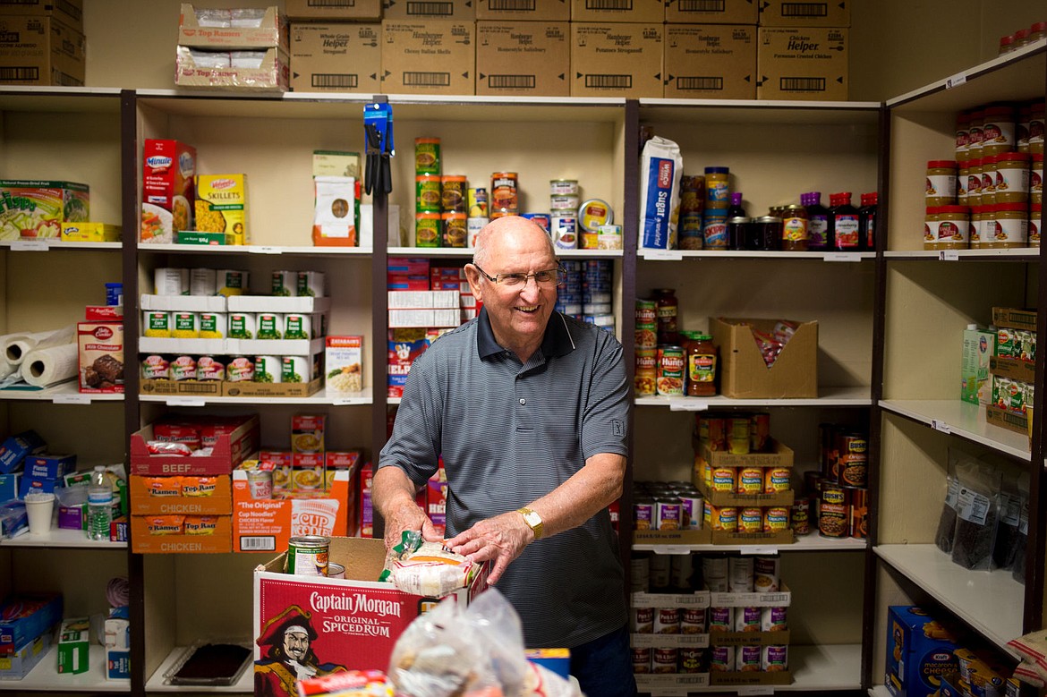 &lt;p&gt;Post Falls resident Darrell Miller smiles as he boxes up non-perishable food Thursday morning in the Christ the King Love Pantry in Coeur d'Alene.&lt;/p&gt;