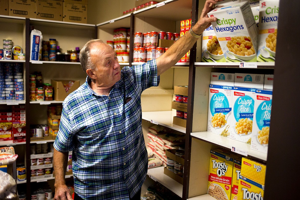 &lt;p&gt;Lee Erwin of Coeur d'Alene grabs a box of breakfast cereal Thursday morning in Christ the King's Love Pantry while gathering food to be donated to people in need. The Pantry distributes foods that are government commodities as well as items donated by community members.&lt;/p&gt;