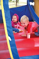 Hunter and baby sister Heidi, nine months, enjoy playing on the moonbounce at last Saturday's 19th annual Dayton Daze celebration.