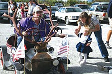 19-month old Amaja West gets a treat from Jim Terry during last Saturday's annual Dayton Daze parade.