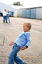 Ashten Nelsen, 4, of Polson experiments with the pencil helicopter handed out by the smoke jumpers from Missoula at the Polson Fly In Saturday.