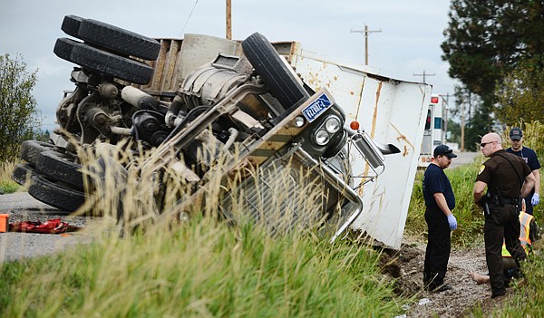 &lt;p&gt;Flathead County Sheriff's Deputy Sam Cox and members of the Evergreen Fire Department respond to the scene of a rollover accident on Helena Flats Road on Monday morning, Sept. 9, north of Kalispell. The driver of the truck was temporarily pinned and extricated from the wreck. He was able to walk away from the scene after answering questions about the wreck, but was taken to Kalispell Regional Medical Center for formal evaluation. (Brenda Ahearn/Daily Inter Lake)&lt;/p&gt;