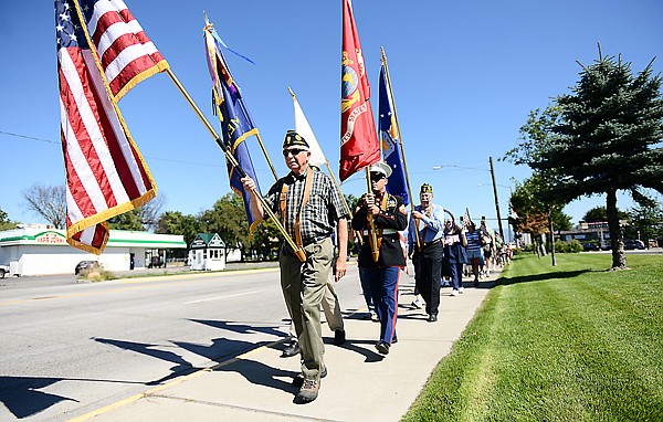 &lt;p&gt;Ron Bauer of the American Legion carries the American flag from the American Legion to Depot Park during the annual Freedom Walk on Wednesday, September 11, in Kalispell. (Brenda Ahearn/Daily Inter Lake)&lt;/p&gt;