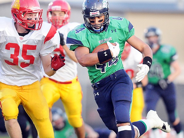 &lt;p&gt;Glacier&#146;s Kellyn Faraone tucks the ball as he tries to elude
Missoula Hellgate defensive back Dan Lympus (35) during first-half
play Friday.&lt;/p&gt;