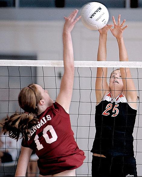 Flathead's Chelsea Vaudt goes up for the block against Helena High's Ann Bugni during the second game Saturday in Kalispell. Flathead won the match in three games. Karen Nichols/Daily Inter Lake