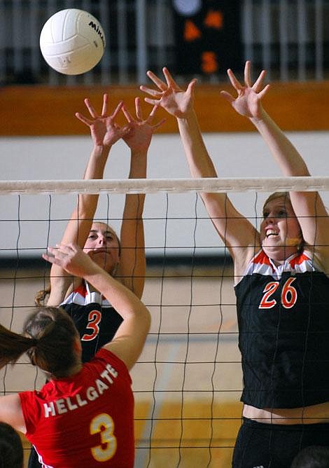 Flathead High School&#146;s Chaela Liss (3) and Danika Johnson (26) go up for a block against Missoula Hellgate&#146;s Brittney Watkins during a volleyball match Tuesday at Flathead. Garrett Cheen/Daily Inter Lake