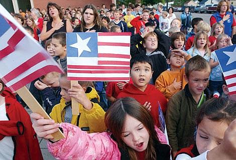 Students sing &quot;The Star Spangled Banner&quot; around the flag pole at Flathead High School on Wednesday morning. Wednesday marked the 191st anniversary of Francis Scott Key's writing of the national anthem, and Flathead High School music department head Allen Slater organized a multischool celebration of the song. Chris Jordan/Daily Inter Lake