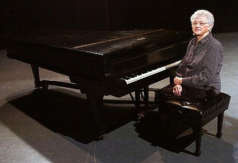 Catherine Bell, president of the Flathead Valley Concert Association, sits Thursday afternoon in the Flathead High School auditorium beside the 9-foot Steinway piano the association purchased in 1989. Bell says that the piano belongs to the association but was bought with the intent of sharing it with the community such as association members, students, the Glacier Orchestra, the Music Teachers Association, Junior Miss and visiting artists. Jennifer DeMonte/Daily Inter Lake