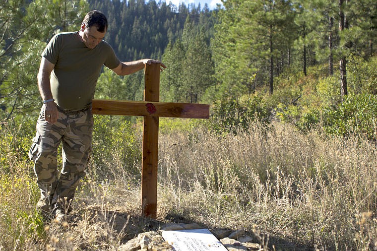 &lt;p&gt;Tom Logan spends a moment in silence next to his son's grave on Sept. 6, Joey's birthday, after securing a wood cross.&lt;/p&gt;