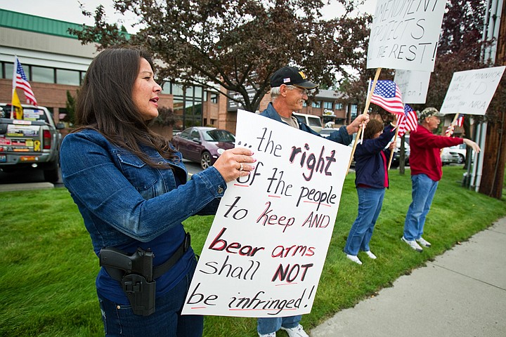 &lt;p&gt;With sidearm holstered, Alanna Grimm joins a rally coordinated by the Reagan Republicans Friday on Northwest Boulevard in Coeur d'Alene. Nearly 20 gathered in support of Second Amendment Rights.&lt;/p&gt;