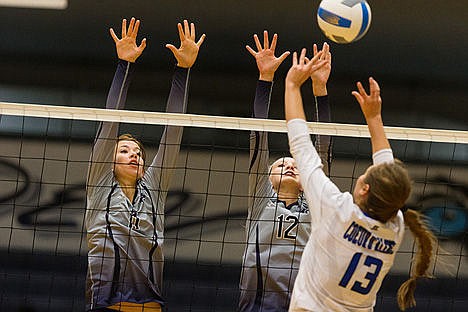 &lt;p&gt;Lake City High School&#146;s Christina Carlson (11) and Arlaina Stephenson (12) go up for the block as Coeur d&#146;Alene High&#146;s Isabella Hollibaugh sets the ball during the first set Thursday at Lake City.&lt;/p&gt;