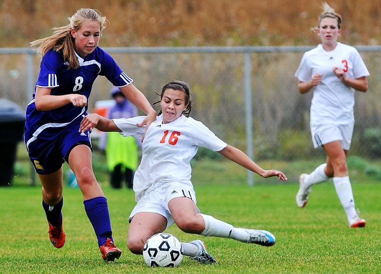 Flathead's Chelsea Shuman slides into a kick toward the goal around Missoula Sentinel's Becca Bixby toward the end of Saturday afternoon's game.