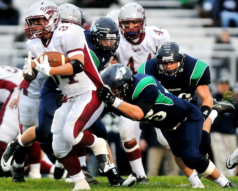 Glacier&#146;s Luke Halliburton grabs hold of Helena High&#146;s Sy Keltner to slow him down during Friday evening&#146;s Class AA game at Legends Stadium.