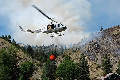 &lt;p&gt;A firefighting helicopter making a water drop over the Pump House Fire in western Montana in August 2008. A drone is spending a week flying over an Idaho fire as a test of its capabilities as a useful firefighting tool.&lt;/p&gt;