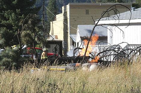 Jamie Doran/Valley Press A tree-cutting accident dropped a tree onto an electrical line and a propane tank and caused a fire at a Superior home Sunday.