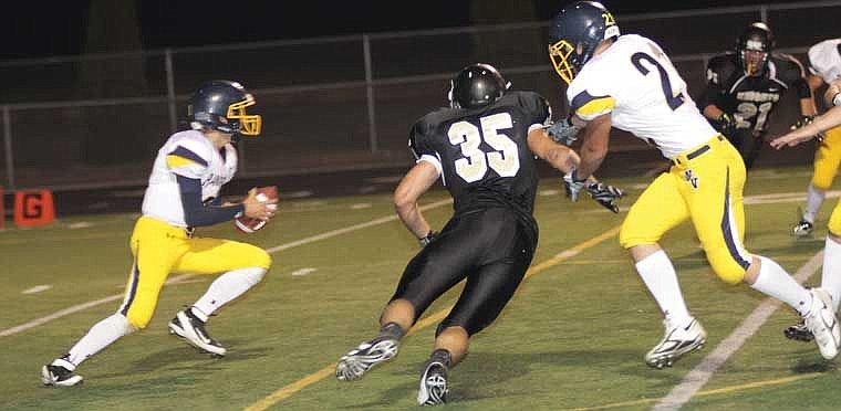 Royal Defender Teddy Mead sidesteps a blocker on his way to the quarterback.