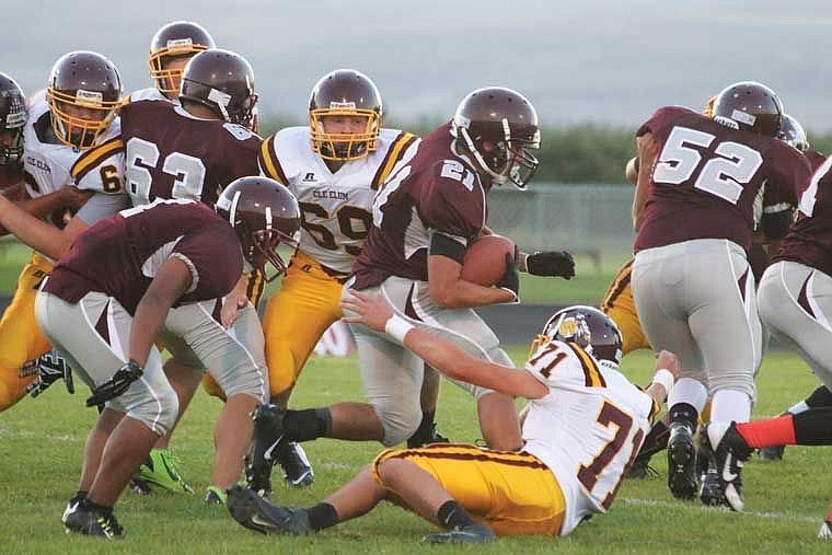 Ball carrier Randy Forestiere runs behind the blocking of Luis Contreras (63), Felix Jimenez (52) and other Warrior linemen.