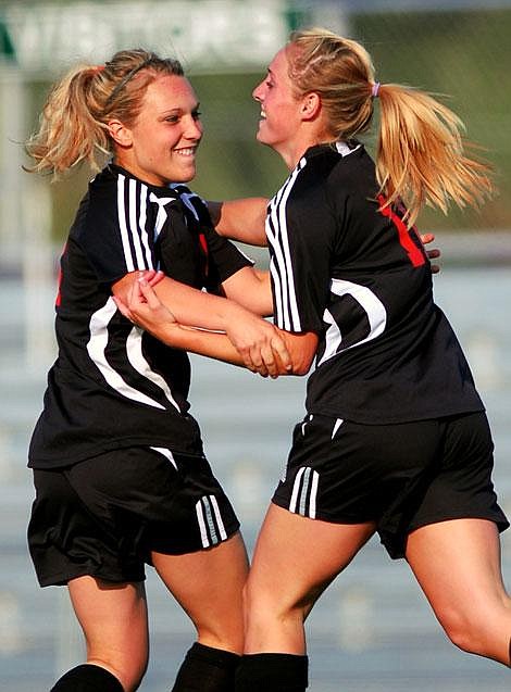 Flathead High School&#146;s Kassi Hebert, left, celebrates with teammate Heidi Windauer after Windauer scored the first goal of the game in first-half action against Glacier at Legends Stadium on Thursday. Flathead defeated Glacier 4-3. Garrett Cheen/Daily Inter Lake