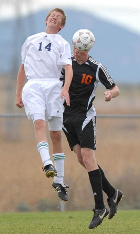 Flathead High School midfielder Connor Cavigli (10) heads the ball before Glacier defender Ian Cavigli (14) during a Western AA soccer match at Kidsports Complex in Kalispell on Tuesday. Connor is Ian&#146;s older brother. Flathead defeated Glacier 6-0. Garrett Cheen/Daily Inter Lake