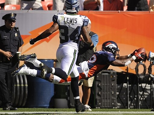 Denver Broncos wide receiver Eddie Royal (19) dives toward the end zone with the football as Seattle Seahawks cornerback Roy Lewis (34) defends during the first half of an NFL football game Sunday, Sept. 19, 2010, in Denver. Royal fumbled the ball out of bounds on the play. Denver beat Seattle 31-14. (AP Photo/Matt McClain)