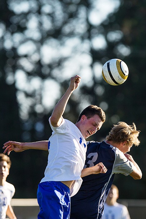 <p>Coeur d'Alene High School's Chase Sanchez goes up for a header against Lake City's Vincent Cavalin.</p>