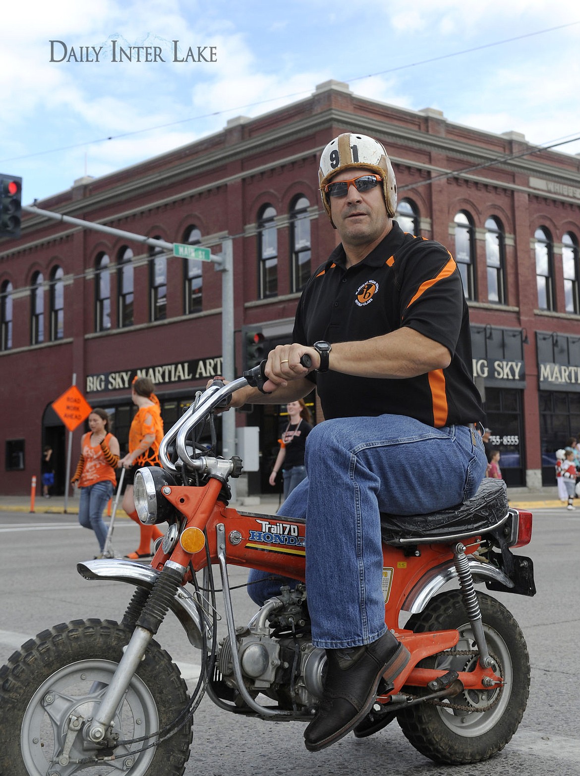 <p>Flathead principal Peter Fusaro rides a mini bike during the high school's homecoming parade on Friday. (Aaric Bryan/Daily Inter Lake)</p>