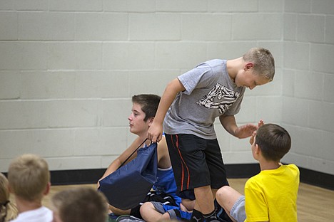&lt;p&gt;After being awarded $500 to go into his college savings fund, Shane Sampson, a 6th grader at Post Falls Middle School, high-fives one of his friends at the Boys and Girls Club of Post Falls Thursday.&lt;/p&gt;