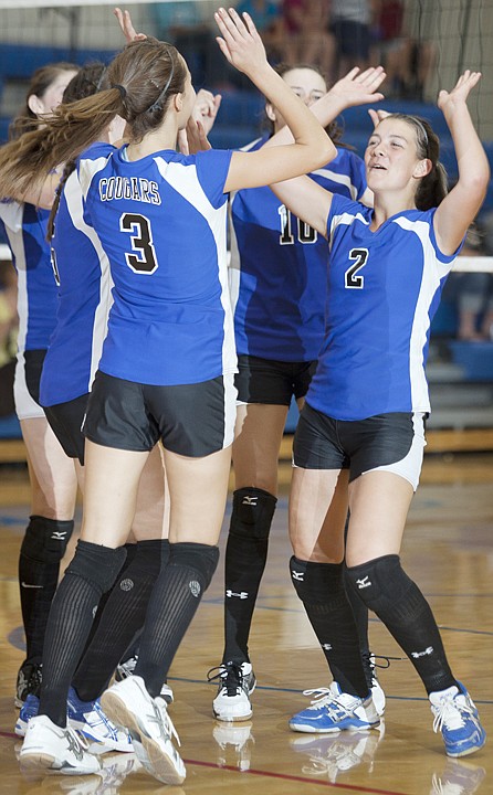 <p>Morgan Paolini (3) and Sarah Smith (2) celebrate after winning
the second set against Bigfork on Tuesday night at Bigfork High
School.</p>