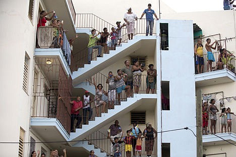 &lt;p&gt;People watch from their apartment building as Pope Francis waves from his popemobile during a procession to the Apostolic Nunciature in Havana, Cuba, Saturday.&#160;&lt;/p&gt;