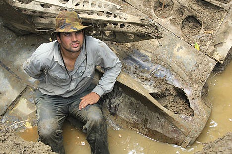 &lt;p&gt;In this 2014 photo provided by Pacific Wrecks, Justin Taylan, founder and director of Pacific Wrecks poses at a World War II airplane wreck site in Papua New Guinea.&#160;&lt;/p&gt;