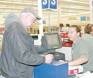 &lt;p&gt;First customer through the checkout Thursday was Earl Goble. (Opal Petrin right)&lt;/p&gt;