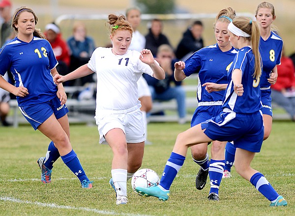 &lt;p&gt;Glacier junior Mikey Staats (11) pushes her way through a host of Missoula Big Sky defenders during Saturday&#146;s Western AA match at Glacier High School. Glacier won 3-1.&lt;/p&gt;