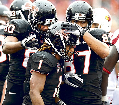 &lt;p&gt;Oregon State's Jacquizz Rodgers (1) is congratulated by teammates after a touchdown against Louisville on Saturday in Corvallis, Ore.&lt;/p&gt;