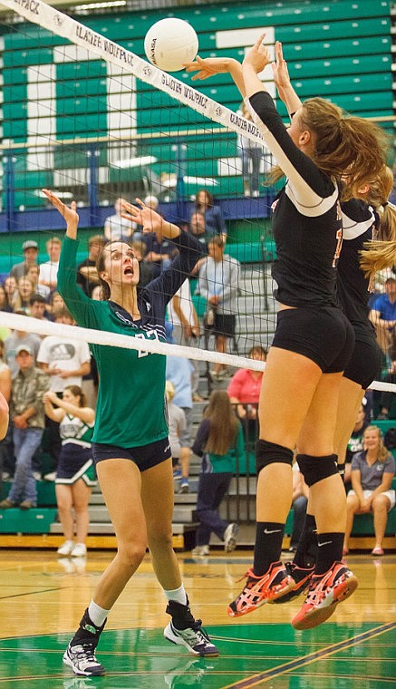 &lt;p&gt;Flathead's Emma Andrews (right) and Cassie Krueger (center) go up for a ball while Glacier senior Tiffany Marks watches Saturday afternoon during Flathead's crosstown victory over the Wolfpack at Glacier High School.&lt;/p&gt;