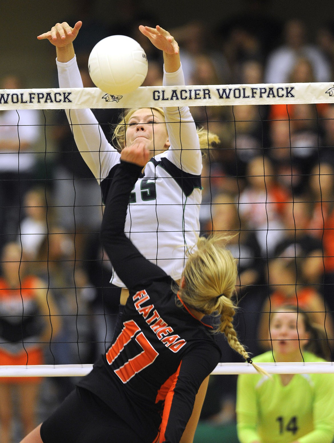 <p>Glacier's Tessa Krueger blocks Flathead's Jessica Simmons shot at the net during the second game of the Wolfpack's 3-0 victory. (Aaric Bryan/Daily Inter Lake)</p>