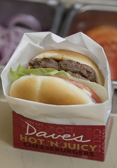 <p>In this Sept. 15, 2011 photo, a new Dave's Hot 'N Juicy Cheeseburger is displayed in the Wendy's research and development laboratory at the company's international headquarters in Dublin, Ohio. (AP Photo/Paul Vernon)</p>
