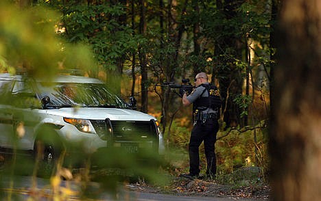 &lt;p&gt;A Pennsylvania state trooper draws his weapon in a wooded area on Snow Hill Road in Price Township, Pa., during a huge manhunt for suspected killer Eric Frein on Sunday near Canadensis, Pa. A Pennsylvania state trooper draws his weapon in a wooded area on Snow Hill Road in Price Township, Pa., during a huge manhunt for suspected killer Eric Frein on Sunday near Canadensis, Pa.&lt;/p&gt;