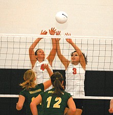 Juniors Sierra Smith and Lindsay Clairmont go up to block the ball during Ronan's conference matchup with Whitefish last Thursday night in Ronan.