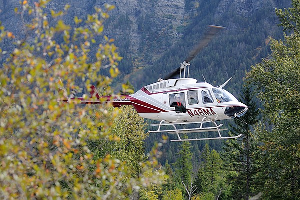 A helicopter from Minuteman Aviation flies low to the ground along Upper McDonald Creek on Wednesday morning as searchers continue to look for Michael William Sloan, 30, of Hungry Horse. More than 25 searches from various organizations took part in the search. Searchers included volunteers, members of the Flathead County Search and Rescue, members of North Valley Search and Rescue, and members of the Flathead County Dive Team.