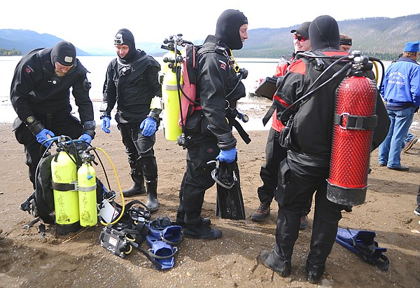 Members of the Flathead County Sheriff's Office Dive Team prepare to enter Lake McDonald on Wednesday in Glacier National Park. Search and rescue personnel are looking for Michael William Sloan, 30, of Hungry Horse, missing since Tuesday.