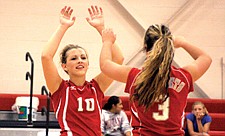 Courtney Dix and Becca Nelson high five during Arlee's three-game win over Hot Springs.